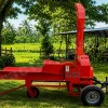Red portable chaff cutter on a farm trailer, with a tall vertical intake/exhaust and the label 'Massive Chaff Cutter' beside a green yard and shed in the background